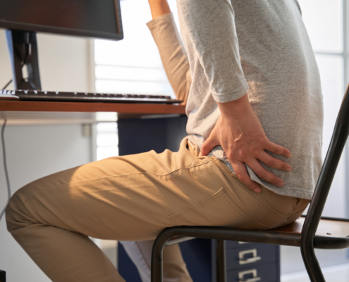 Man with backache working from home 