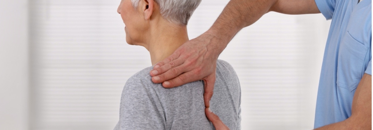 osteopath treating a woman's shoulder