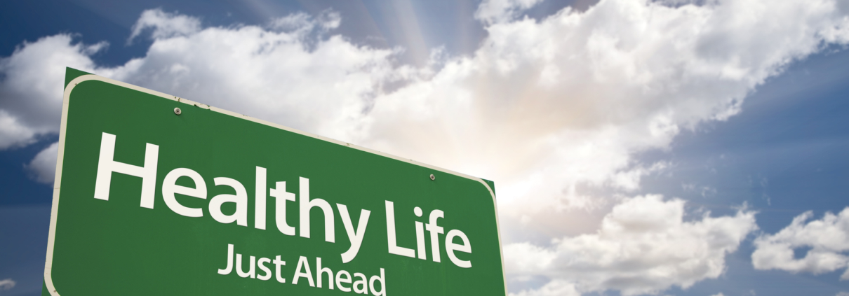 Healthy Life Green Road Sign Over Clouds