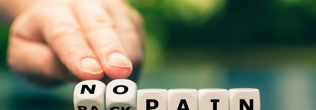 Hand turns dice and changes the expression "back pain" to "no pain".
